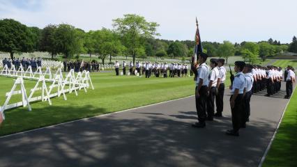 French and American military stand in formations during the ceremony. 