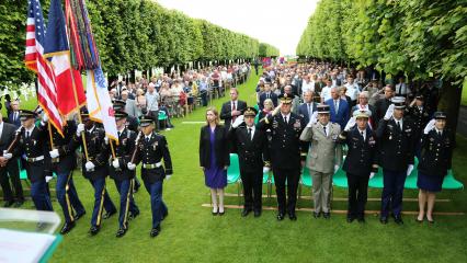 Attendees stand at the beginning of the ceremony. 