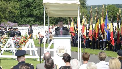 Lussenhop stands at the podium to deliver remarks. 