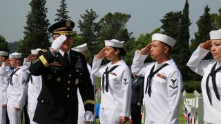 Sailors salute an Army officer during the ceremony. 