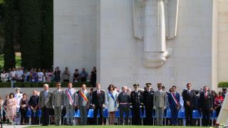 Attendees stand at the beginning of the ceremony. 